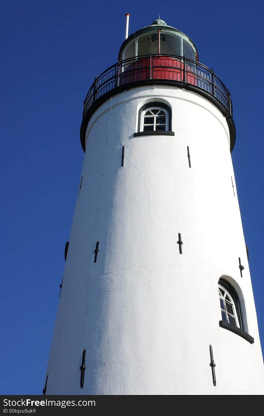 White lighthouse, blue sky.