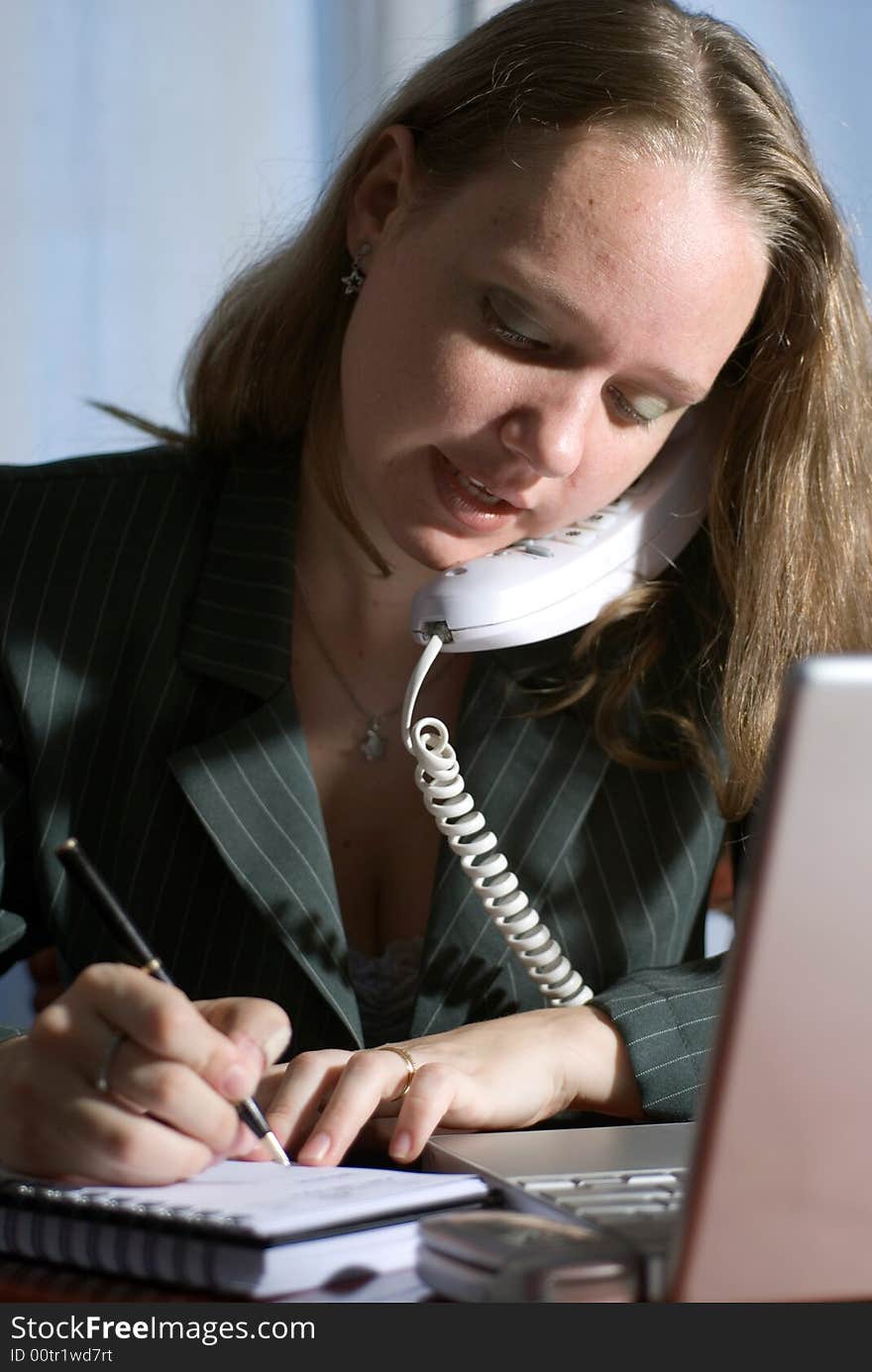 Woman in a business suit on the phone