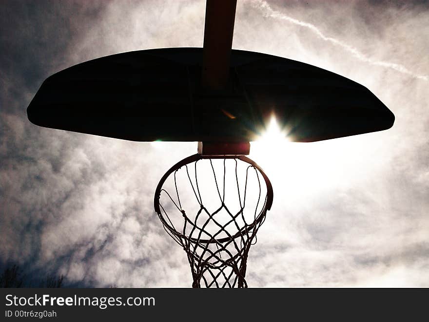 Basketball hoop silhouetted.