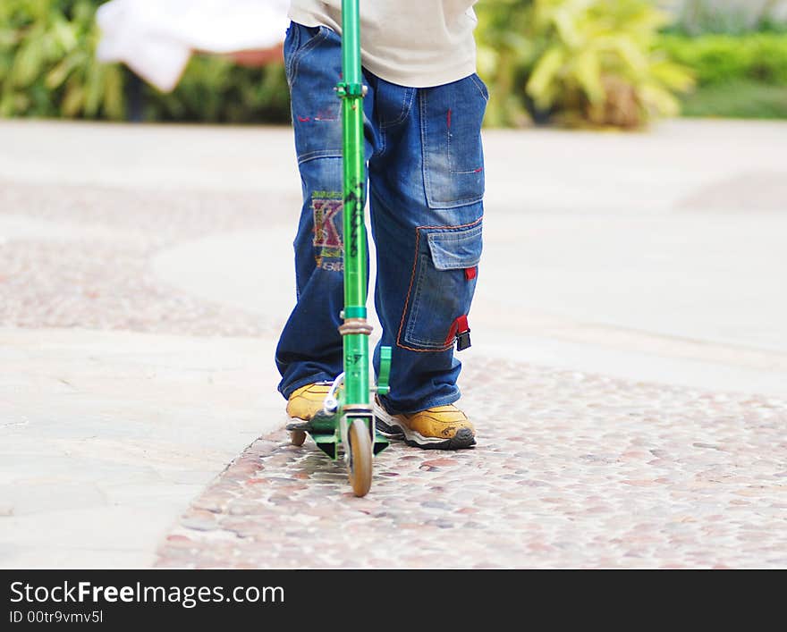 A boy playing and running with a pedal cycle,or push bike. A boy playing and running with a pedal cycle,or push bike.