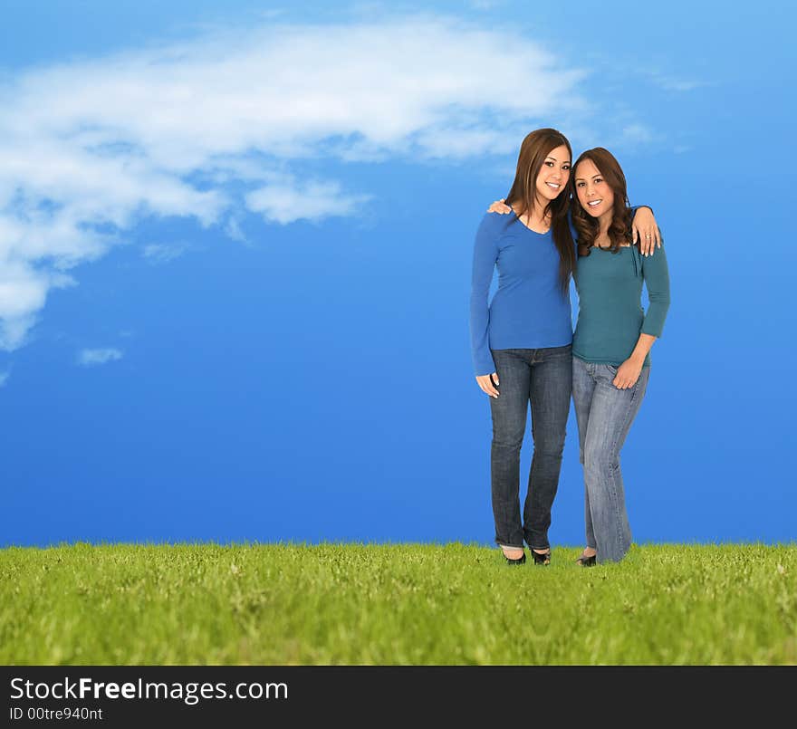 Two girls standing on the grass outdoor. great concept for spring or summer. Two girls standing on the grass outdoor. great concept for spring or summer