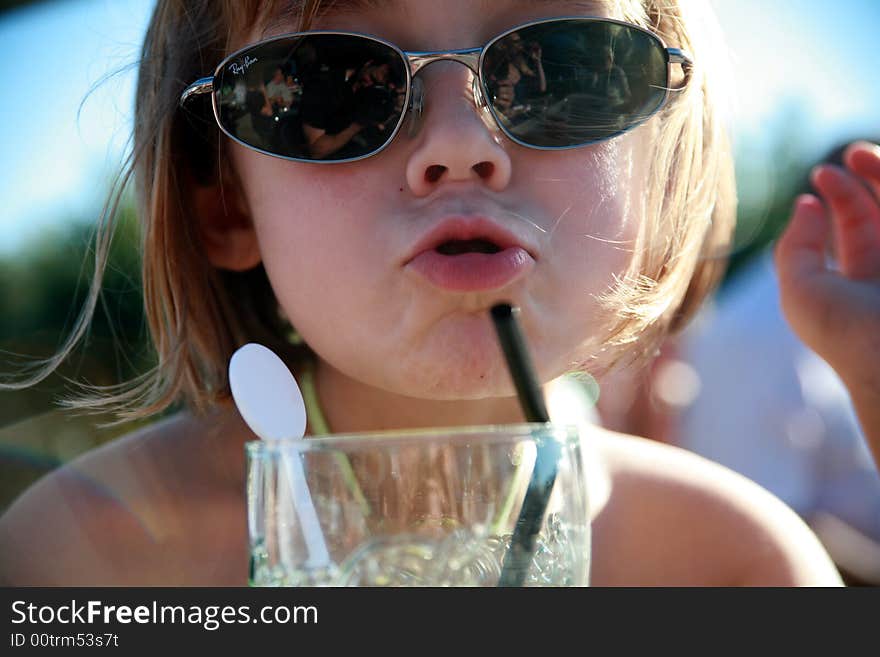 Cool Girl blowing a kiss and drinking on a hot summer day. Cool Girl blowing a kiss and drinking on a hot summer day