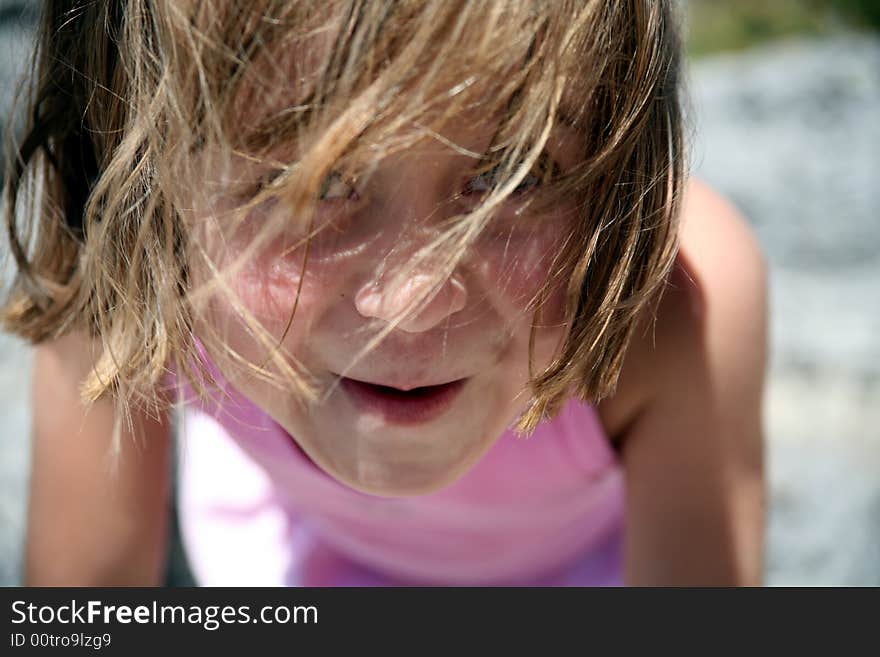 Cool Girl looking at camera with messy hair on a hot summer day. Cool Girl looking at camera with messy hair on a hot summer day