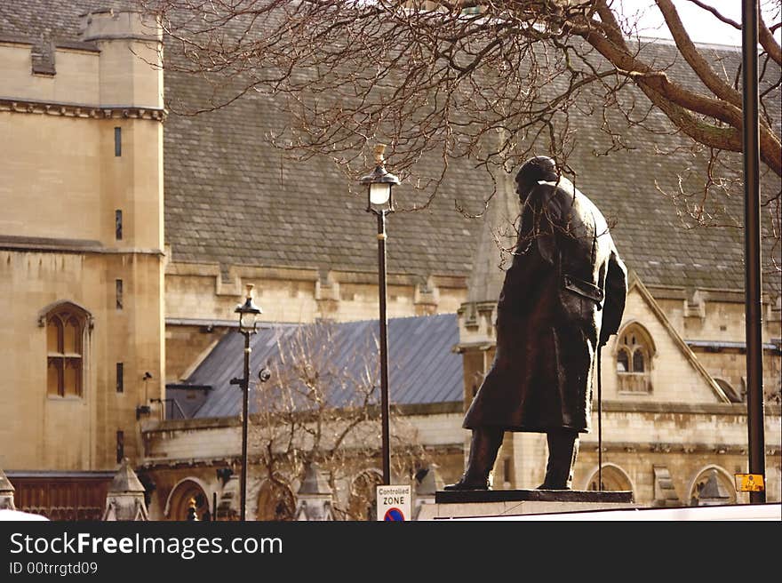 Churchill's statue is in the Houses Parliament square. The old tired men in military coat is going to work in the parliament forever. Churchill's statue is in the Houses Parliament square. The old tired men in military coat is going to work in the parliament forever.