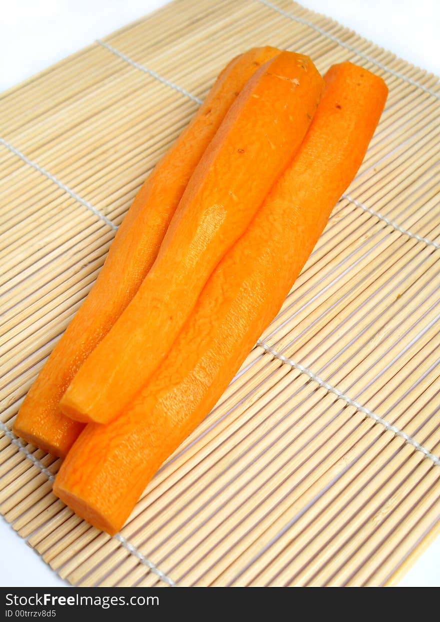 Peeled carrot on bamboo