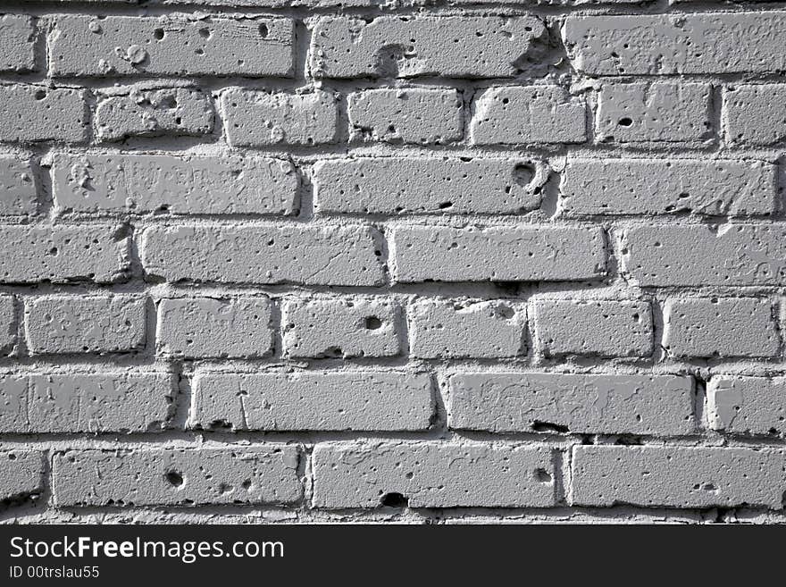 Brick wall painted by a white paint