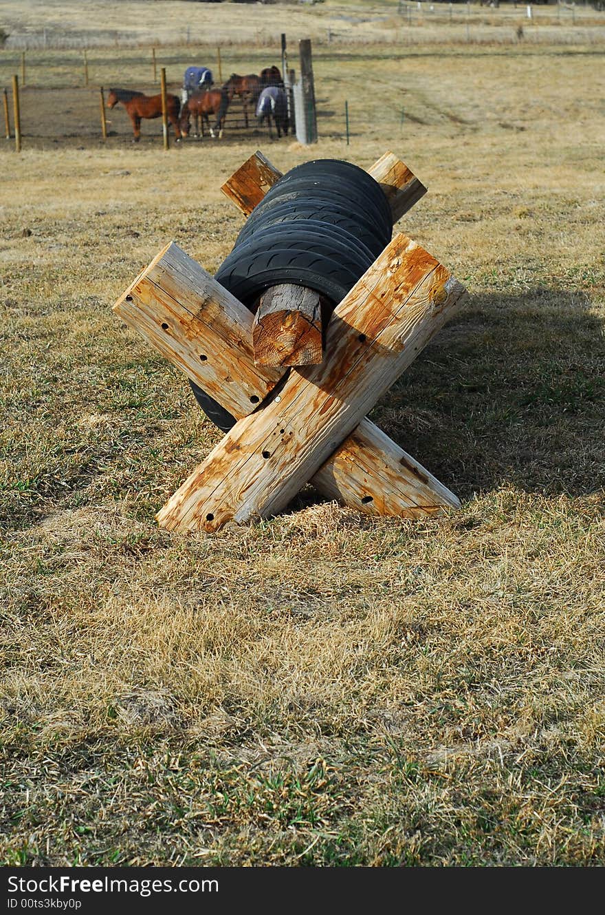 Obstacle on cross-country course with horses in background. Obstacle on cross-country course with horses in background.