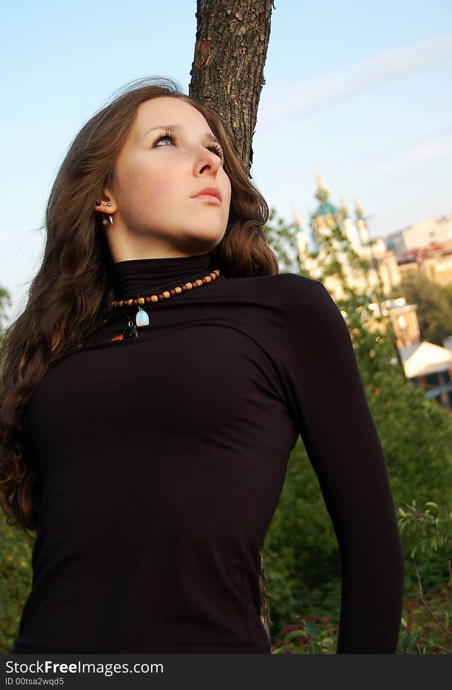 Beautiful teenage girl near the tree