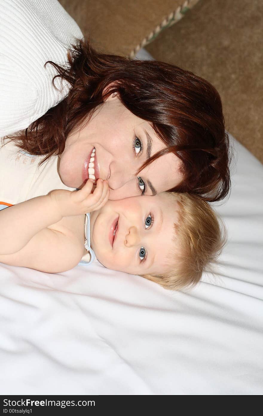 The portrait of the small beautiful boy which lays near to mum. The portrait of the small beautiful boy which lays near to mum