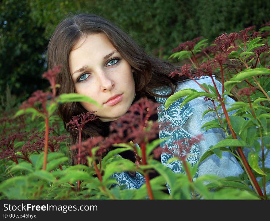 Beautiful teenage girl in a high grass