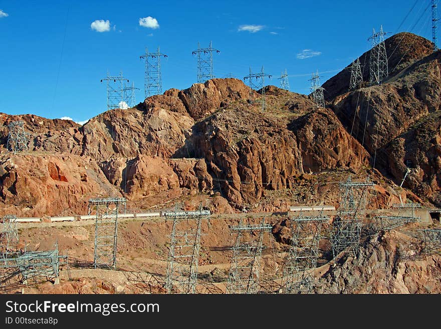 Many electric towers surrounding the area of Hoover Dam. Many electric towers surrounding the area of Hoover Dam.