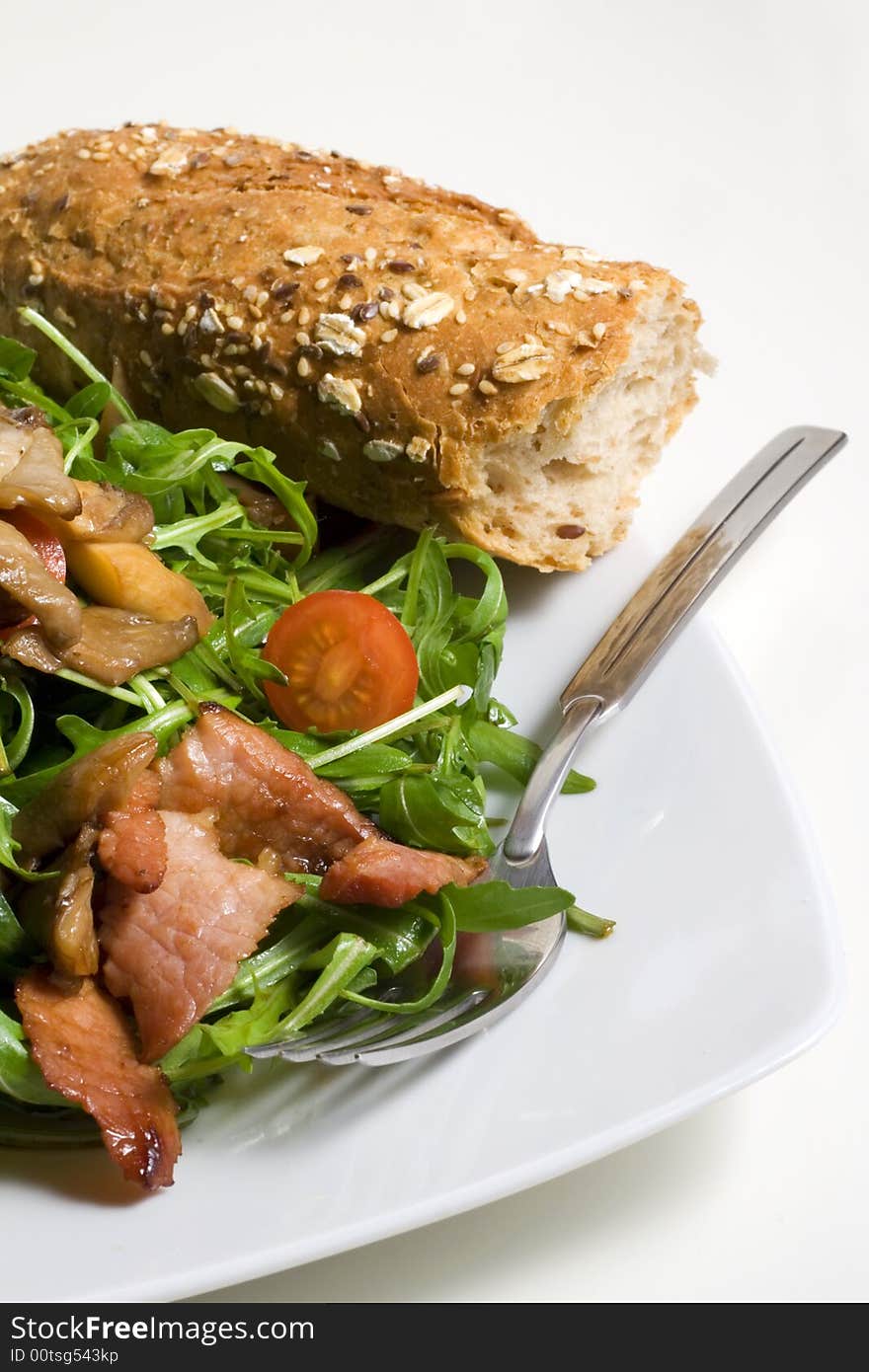 Rocket salad with ham and mushrooms and baguette. Rocket salad with ham and mushrooms and baguette