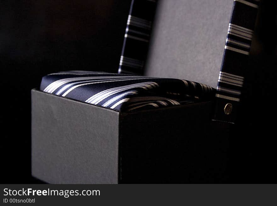 Silk necktie with box, isolated on the black background. Silk necktie with box, isolated on the black background