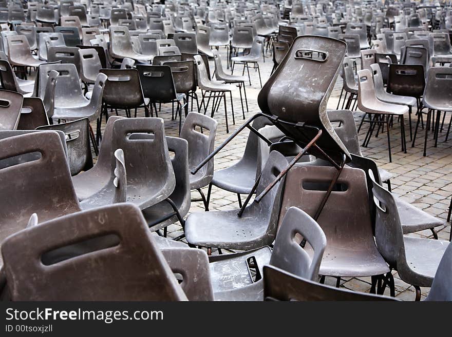 Abandoned plastic chairs after an outdoor event. Abandoned plastic chairs after an outdoor event