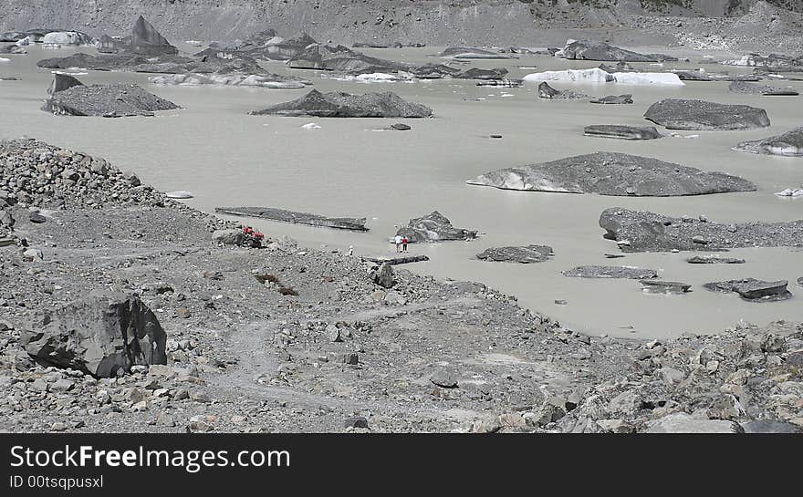 Glacial iceberg from the Tasman glacier on the tasman melt lake, New Zealand. Images taken from top of moraine looking down onto tourist pick up wharf. Glacial iceberg from the Tasman glacier on the tasman melt lake, New Zealand. Images taken from top of moraine looking down onto tourist pick up wharf