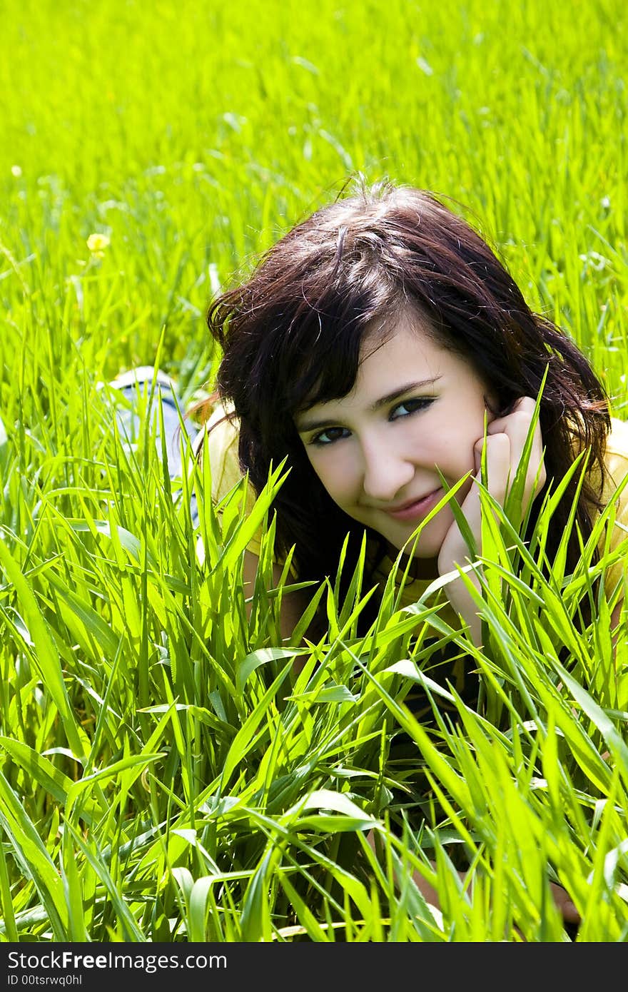 Smiling blonde woman portrait over the grass. Smiling blonde woman portrait over the grass