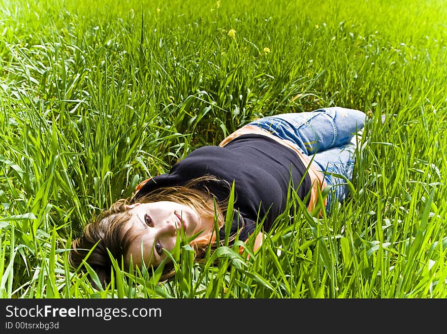 Smiling blonde woman portrait over the grass. Smiling blonde woman portrait over the grass