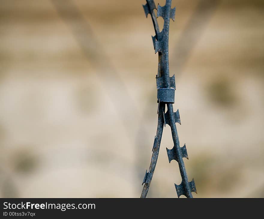 Close up of two strands of barbed wire clasped together