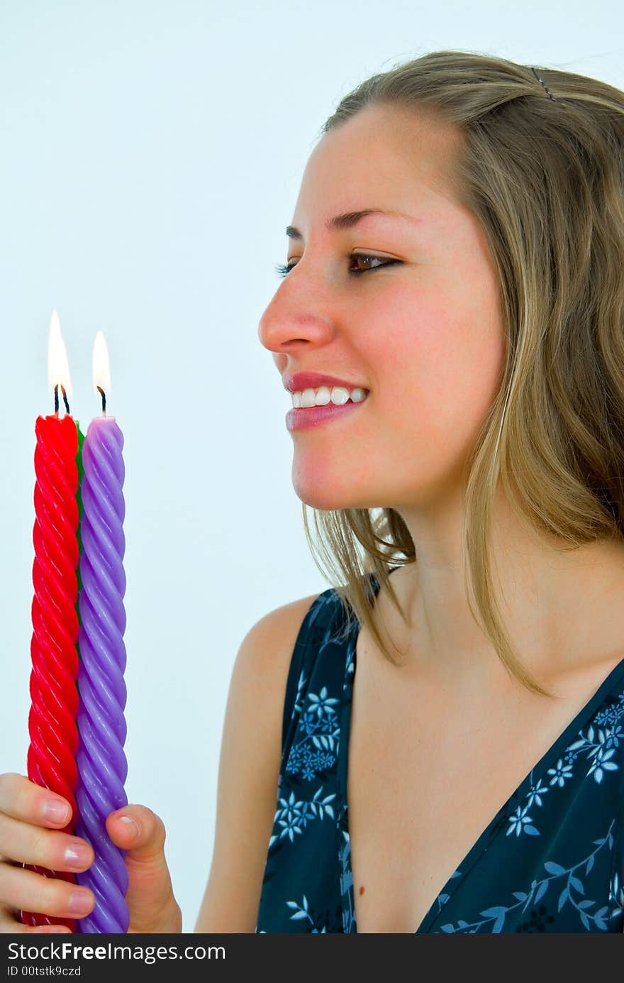 Young gorgeous lady looking at fire of candles. Young gorgeous lady looking at fire of candles