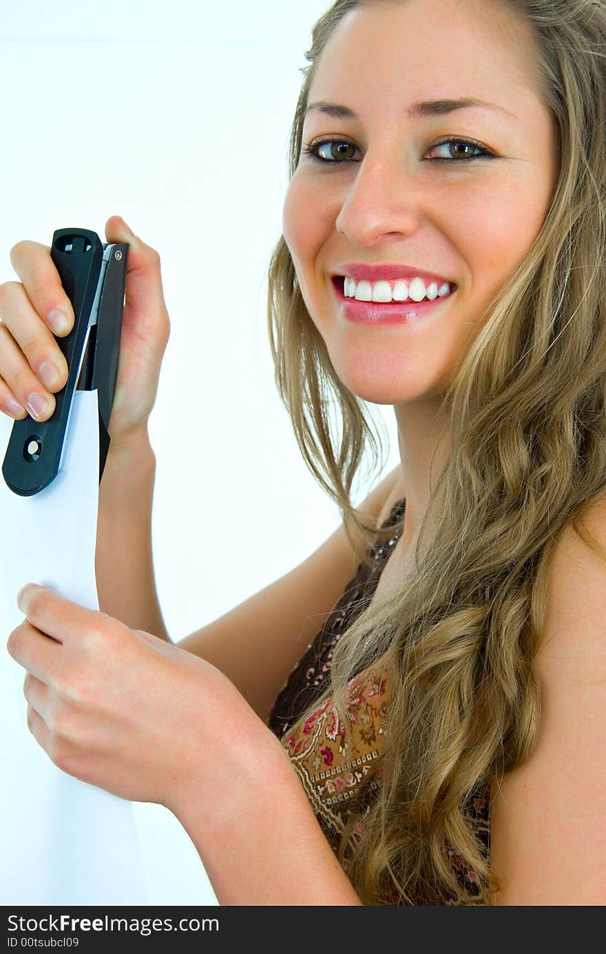 Smiling office girl with a stepler and paper