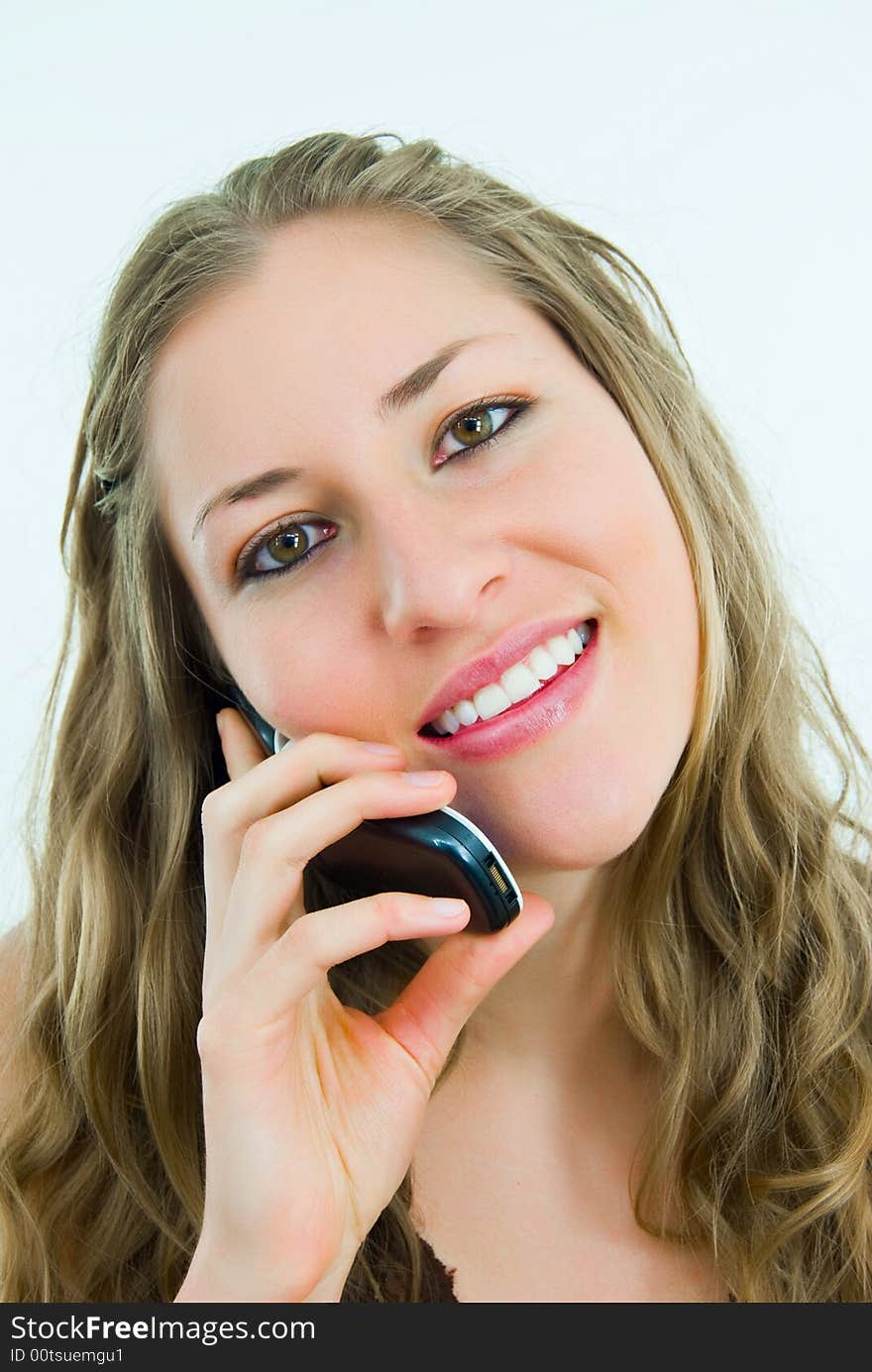 Smiling pretty lady talking to a mobile telephone. Smiling pretty lady talking to a mobile telephone