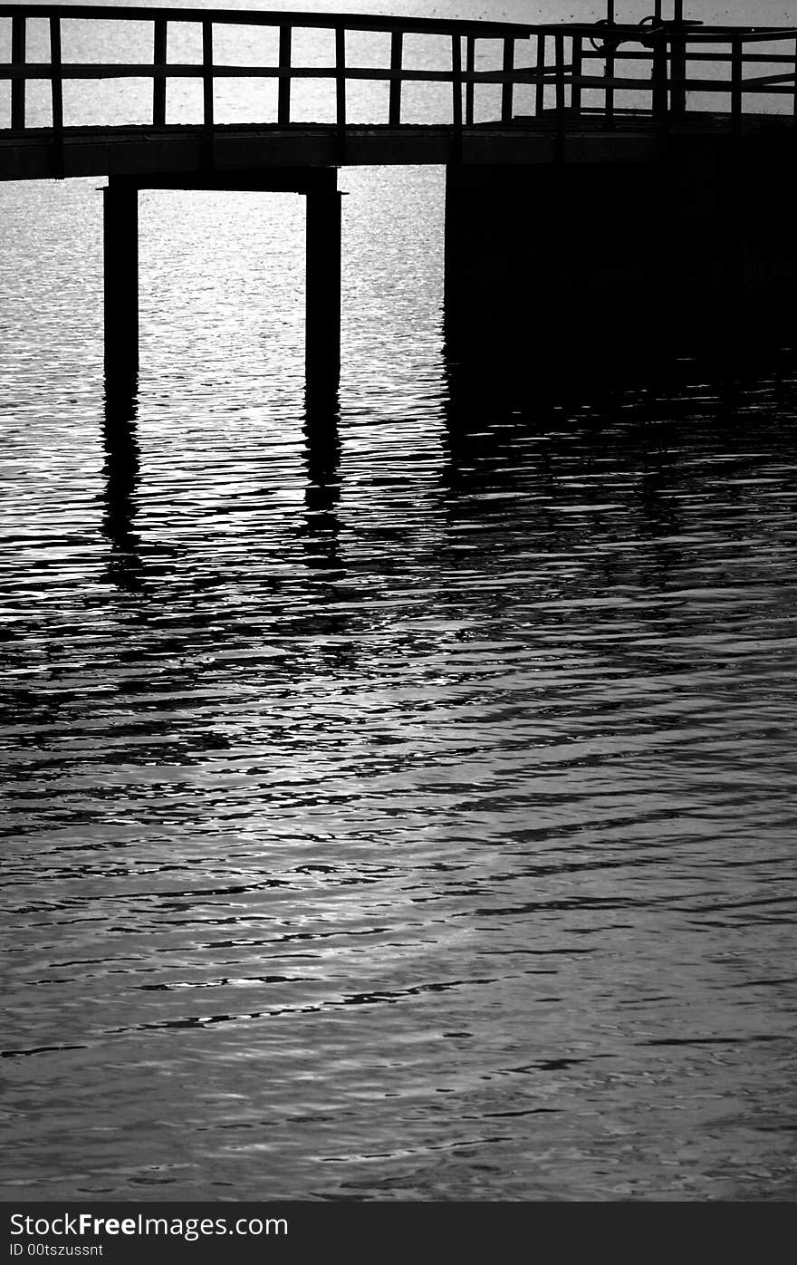 Silhouette of a pier in black and white