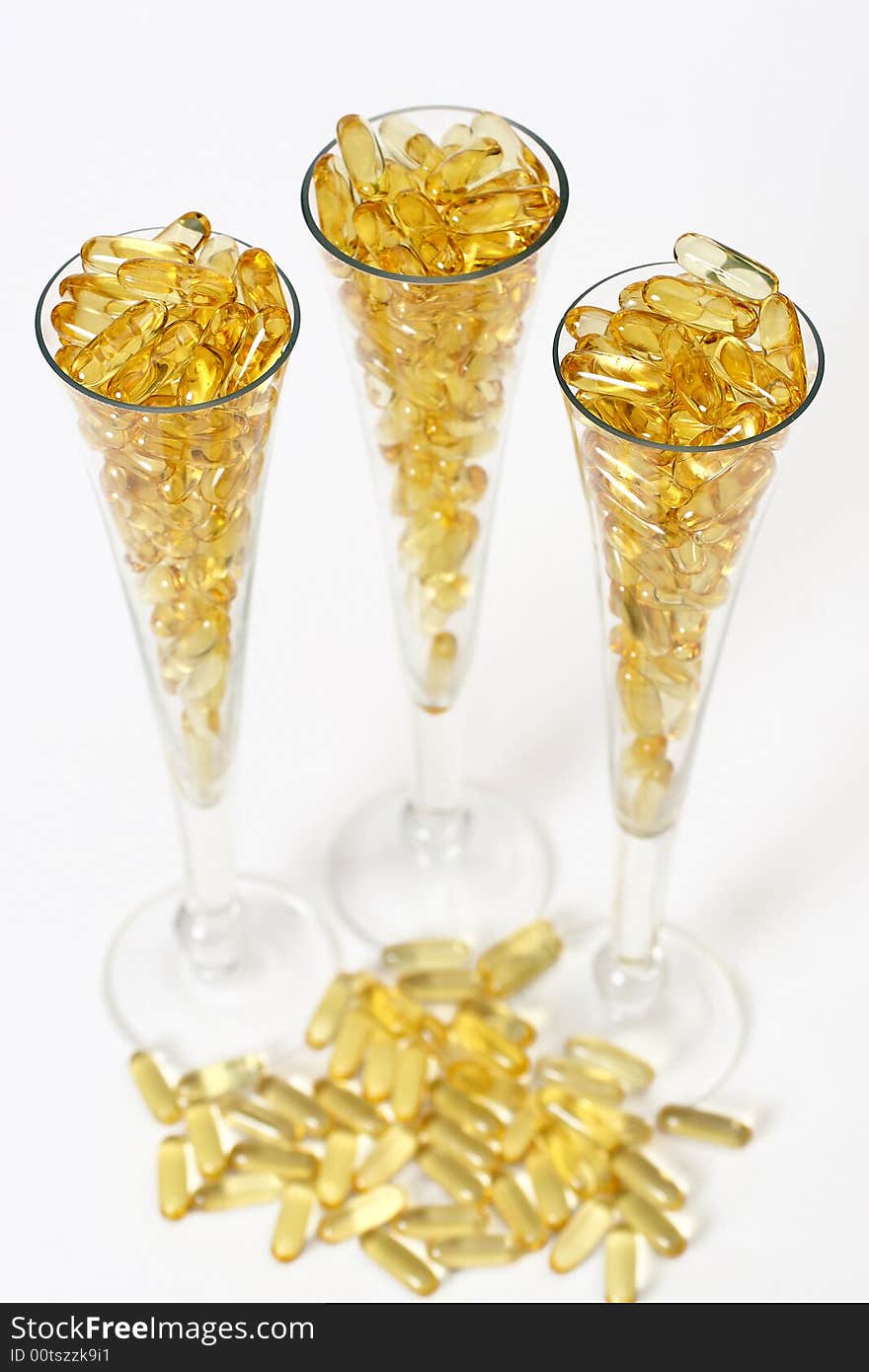 Three glasses with gold shiny boluses. Three glasses with gold shiny boluses