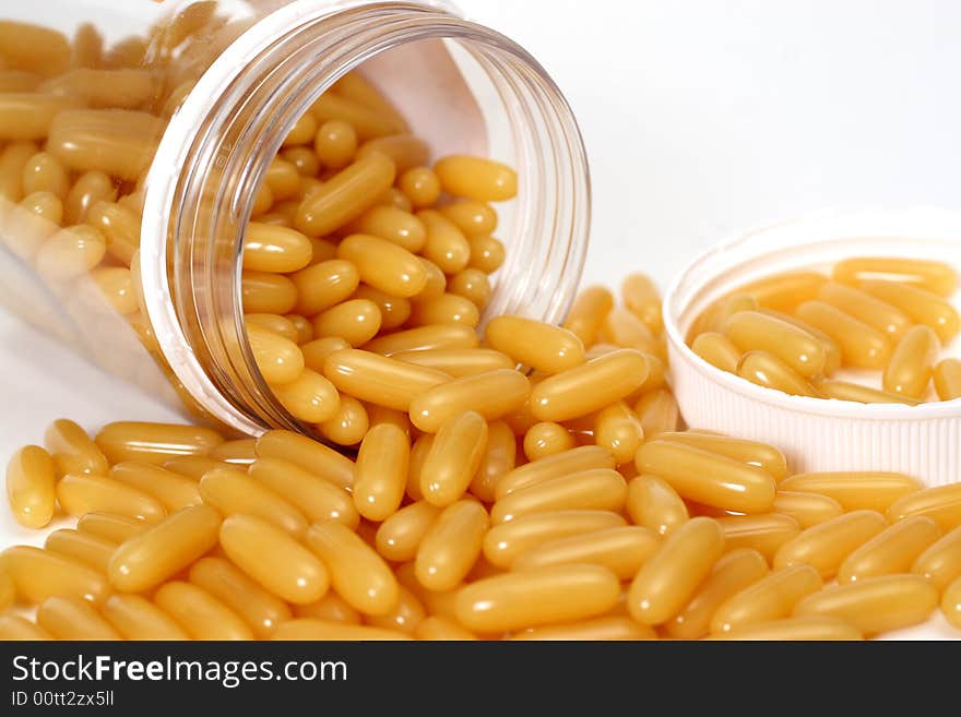 Lying pot with orange capsules. Lying pot with orange capsules