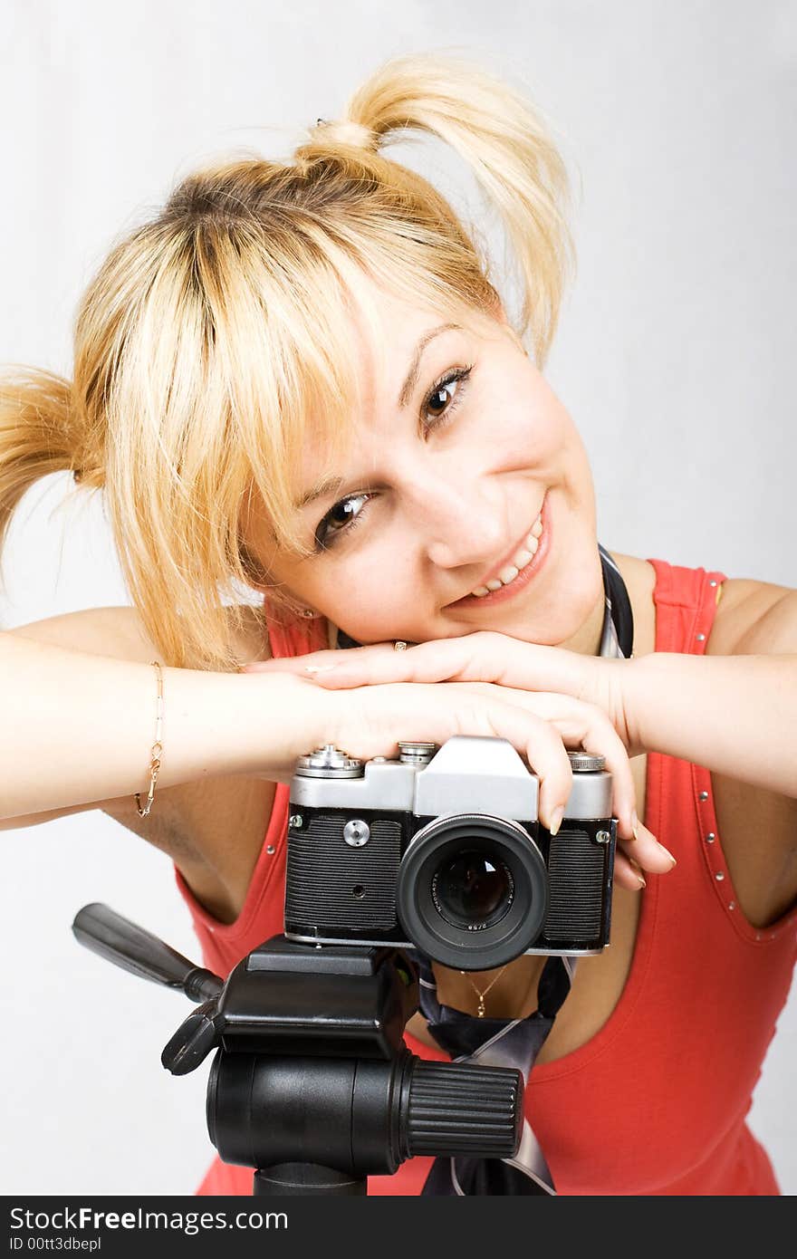 Young girl with vintage camera and tripod