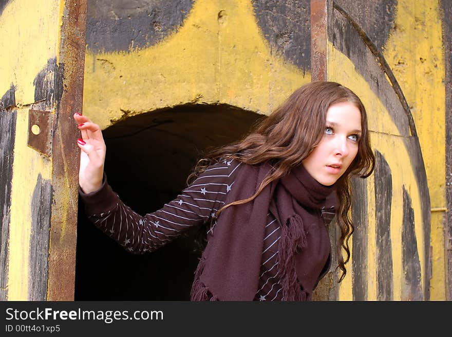 Teenage girl opening old painted gates. Teenage girl opening old painted gates