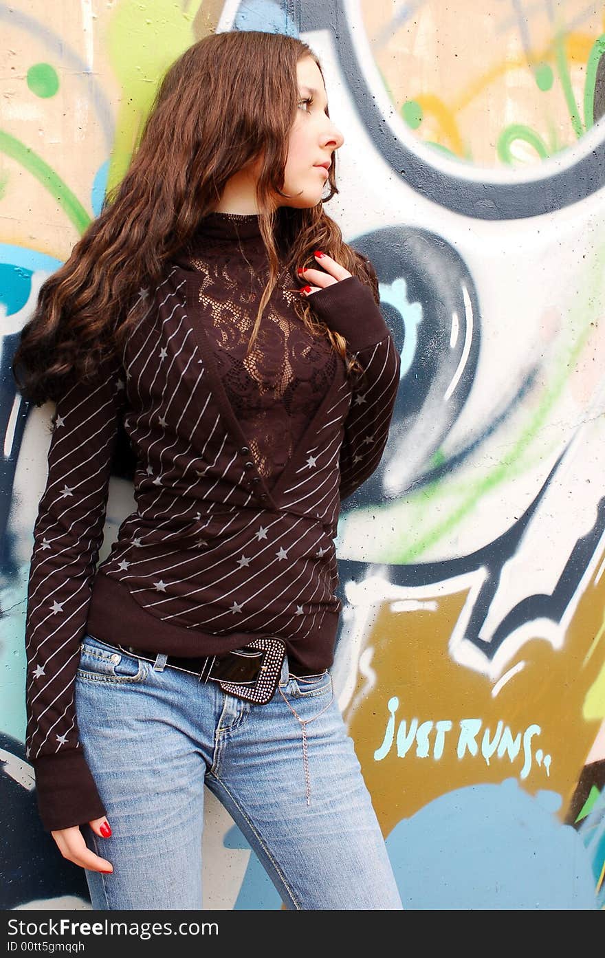 Girl near the graffiti wall