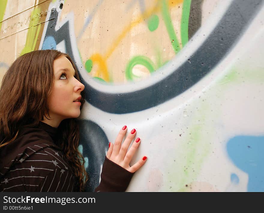 Girl near the graffiti wall