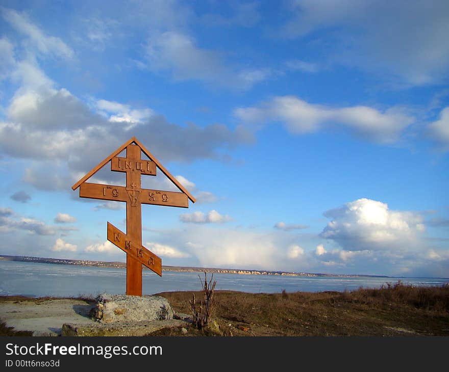 Winter. Wooden christian cross on the coast of the river. Winter. Wooden christian cross on the coast of the river.