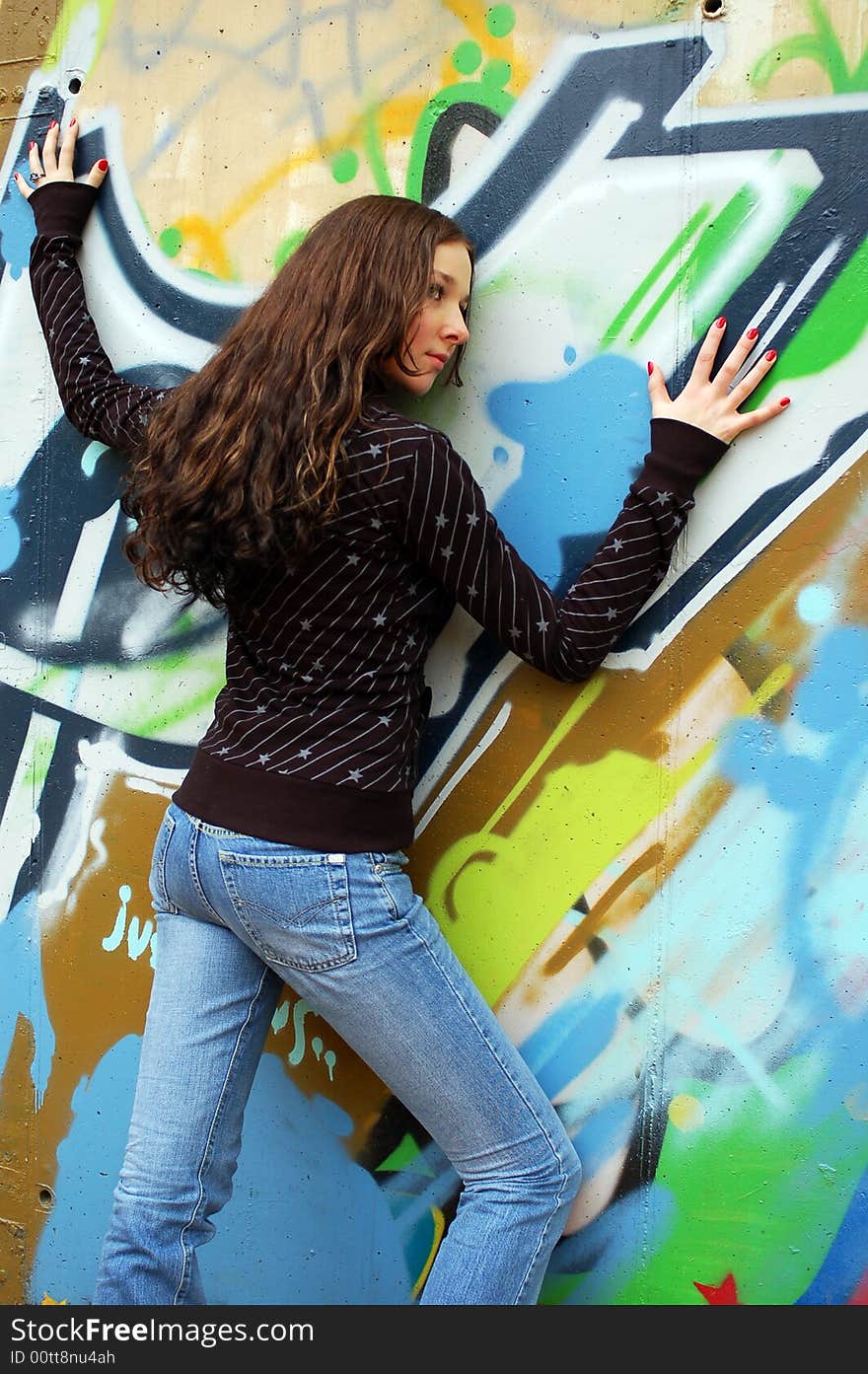 Girl near the graffiti wall