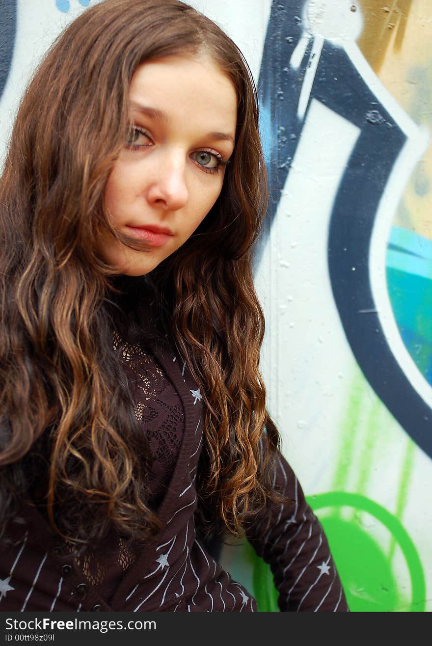 Teenage girl near the graffiti wall