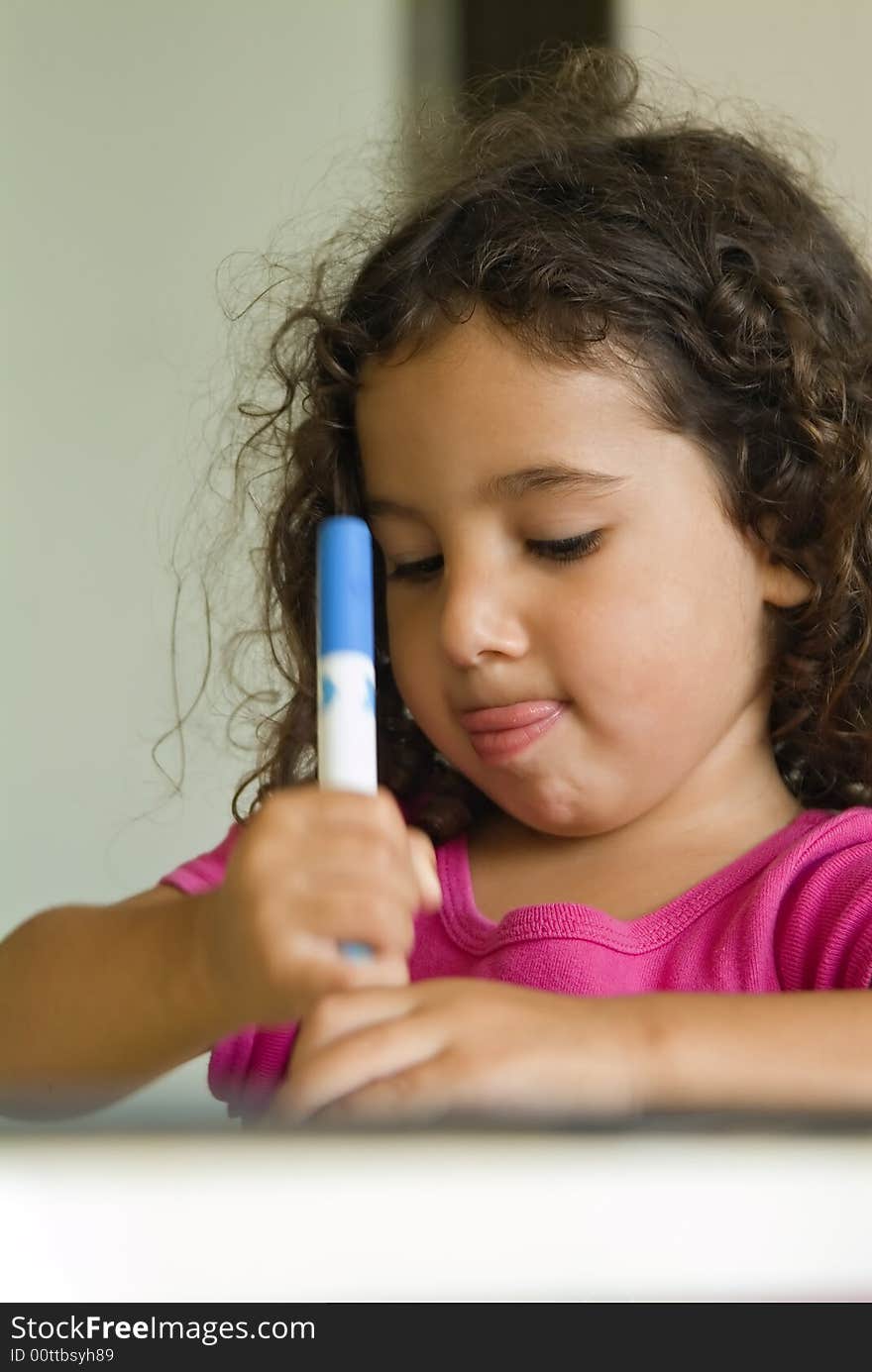 Little girl painting at home