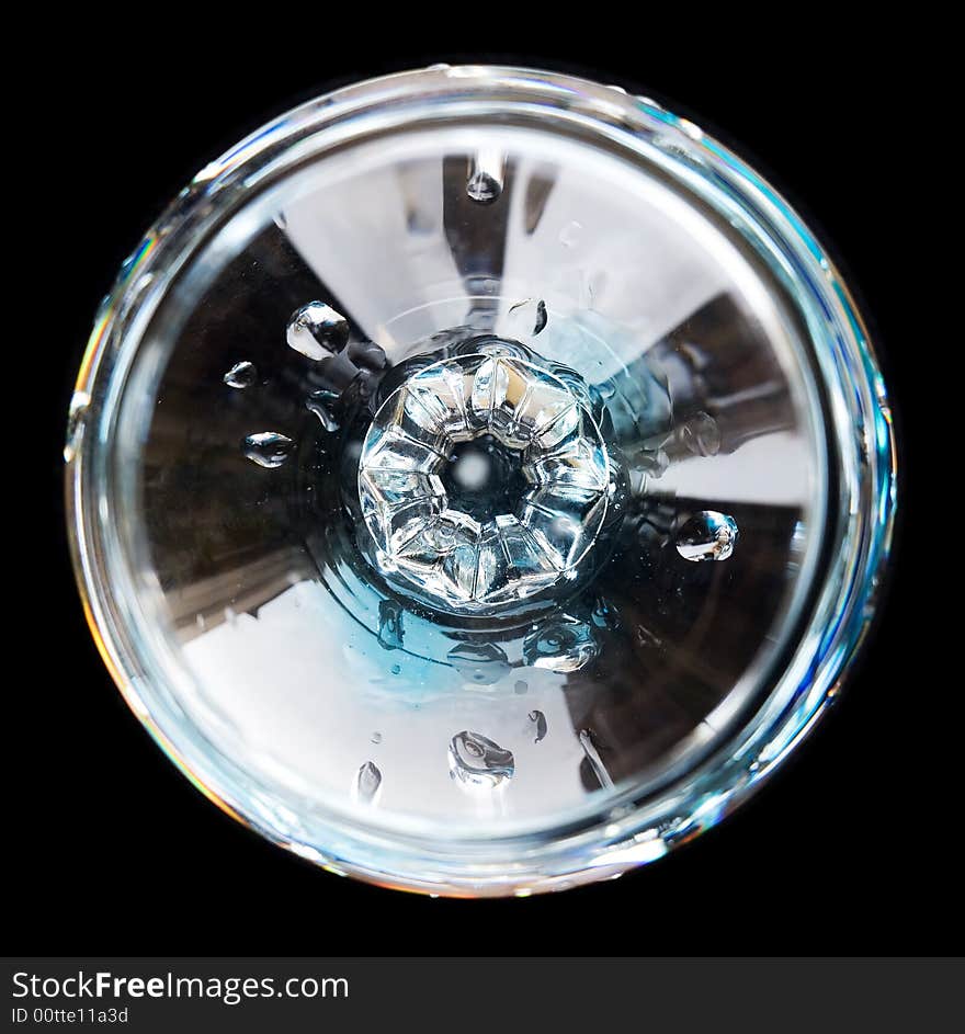 Cognac/brandy glass with water drips from top isolated on black background. Cognac/brandy glass with water drips from top isolated on black background