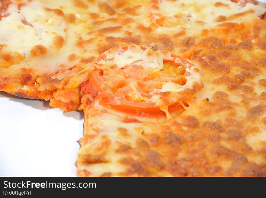 Close up of a pizza which has had a slice cut. Close up of a pizza which has had a slice cut