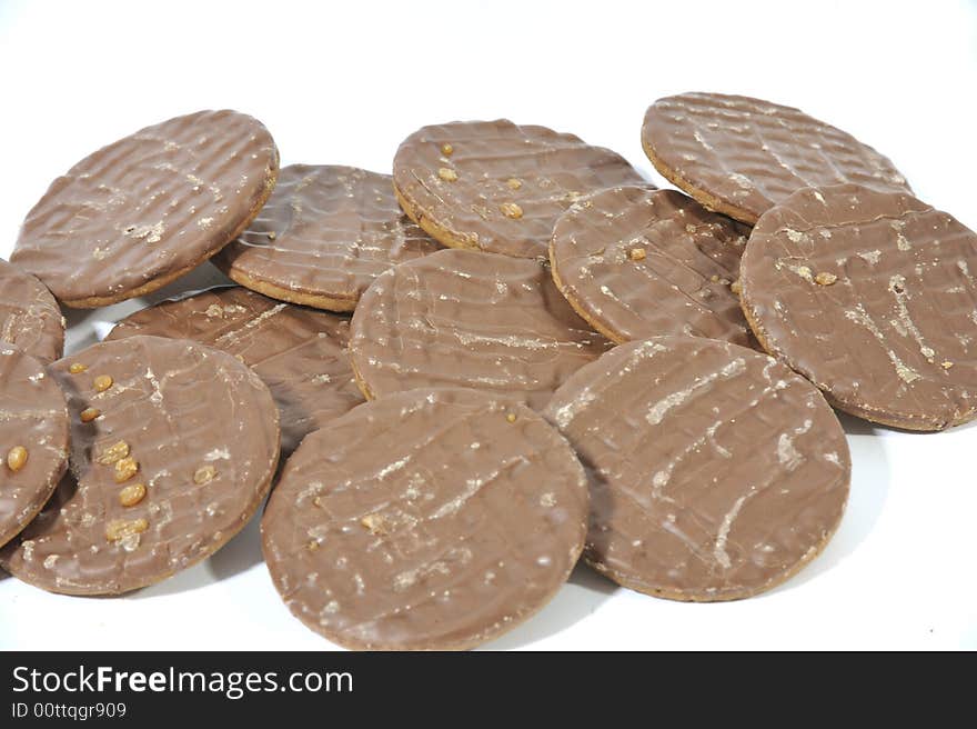 Pile of Chocolate Biscuits on a white background.