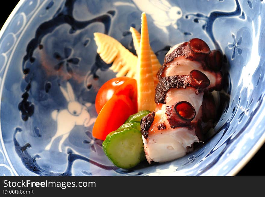 Appetizer salad of grilled octopus with fresh vegetables. Appetizer salad of grilled octopus with fresh vegetables