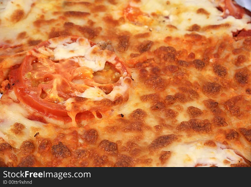 Rectangle image, Close up of a cheese & Tomato pizza with large tomato slice in the middle. Rectangle image, Close up of a cheese & Tomato pizza with large tomato slice in the middle