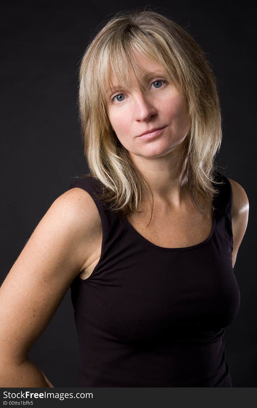 The woman in a black jacket on a dark background