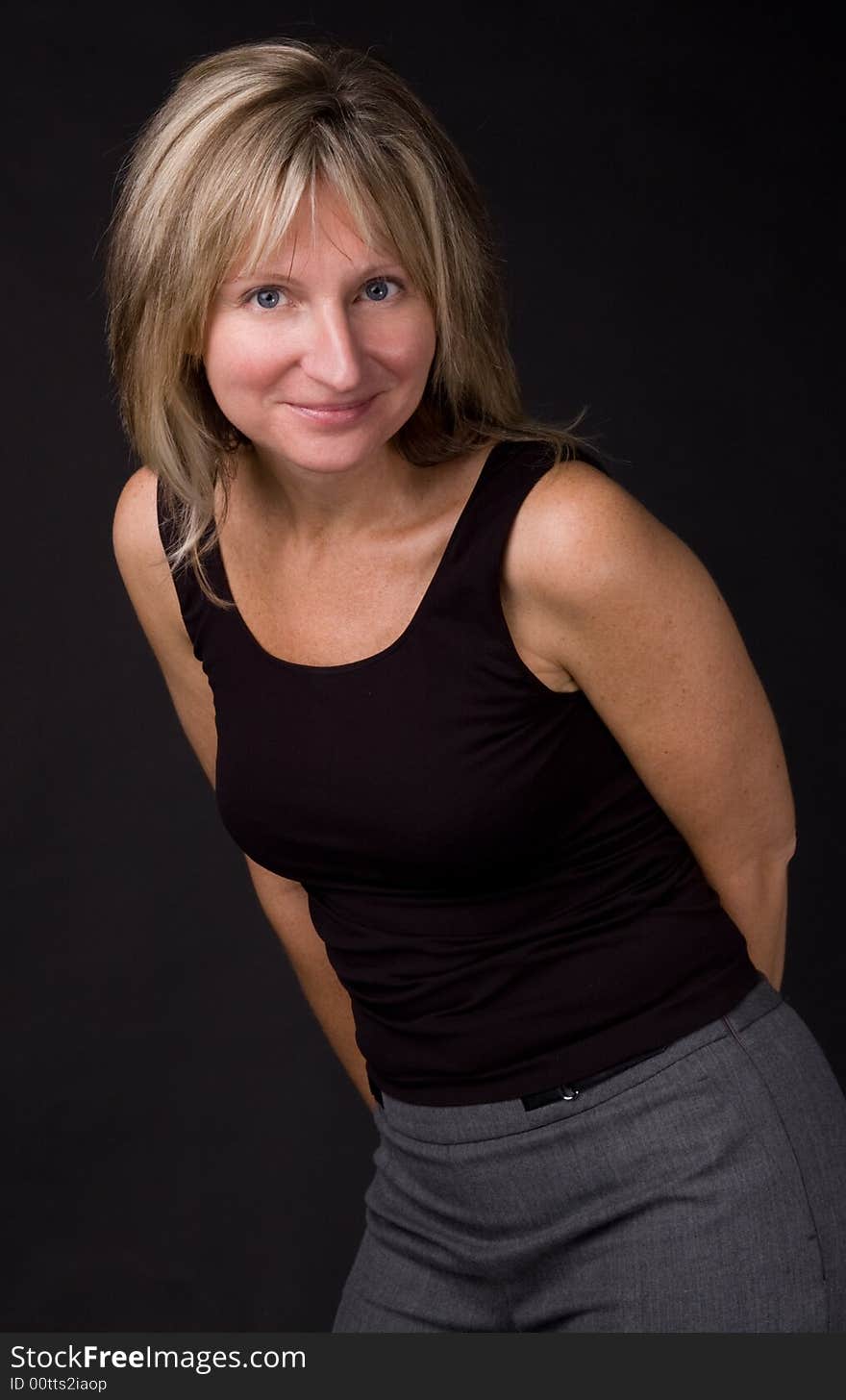 The woman in a black jacket on a dark background