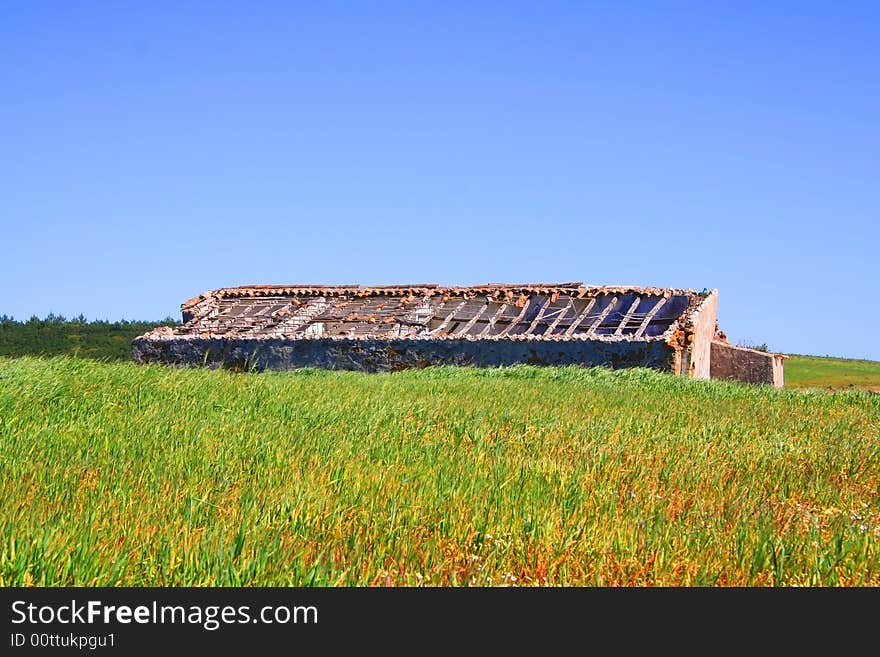 Abandoned building in surrounded by lush grassland in Portugal Algarve Coast. Abandoned building in surrounded by lush grassland in Portugal Algarve Coast