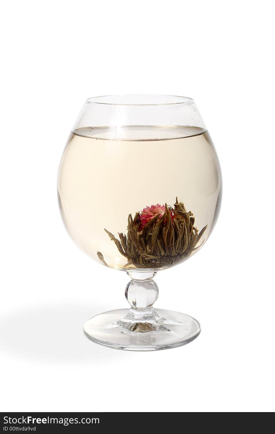 Glass with a flower green tea on white background