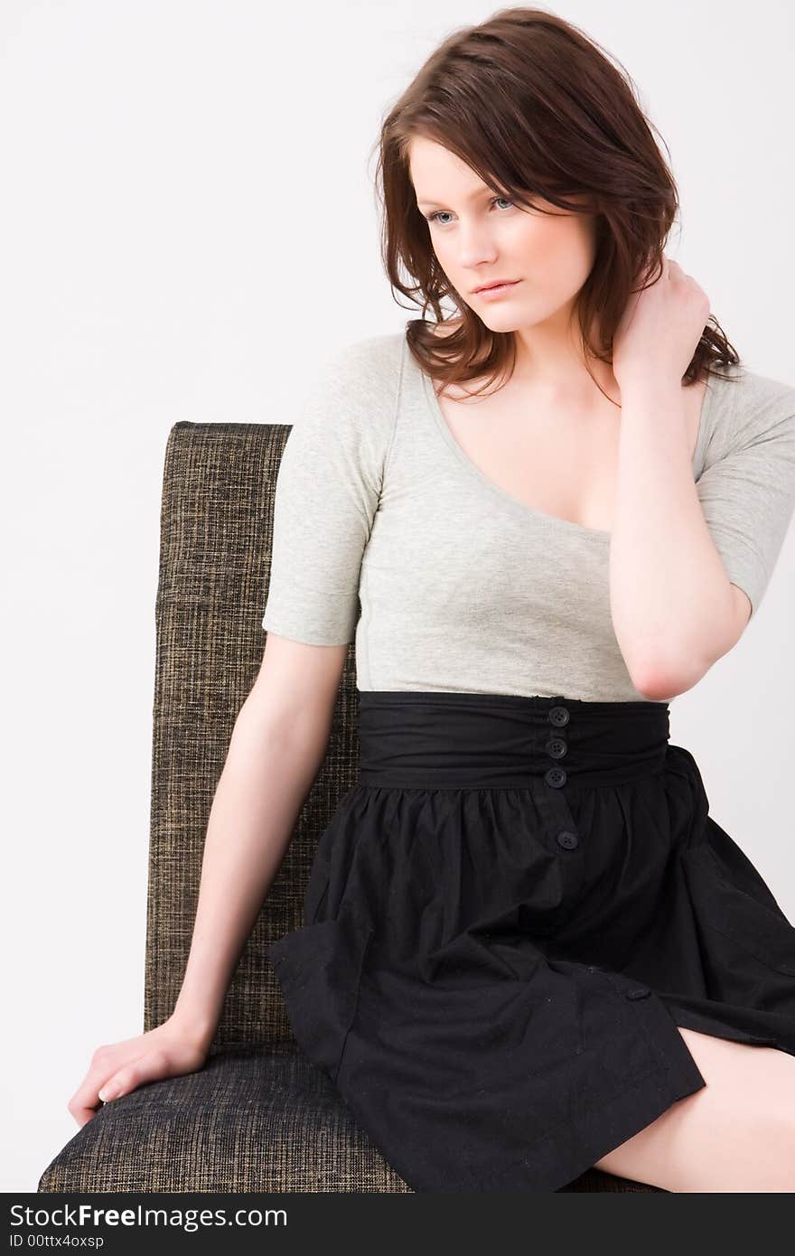 Portrait of young beautiful woman sitting on the chair