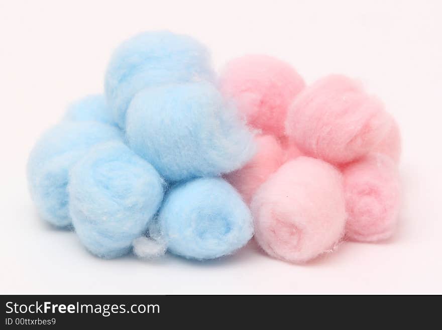 Blue and pink hygienic cotton balls isolated on a white background