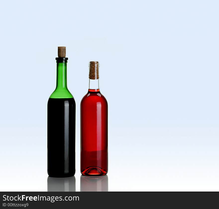 Two bottles of wine on light blue background