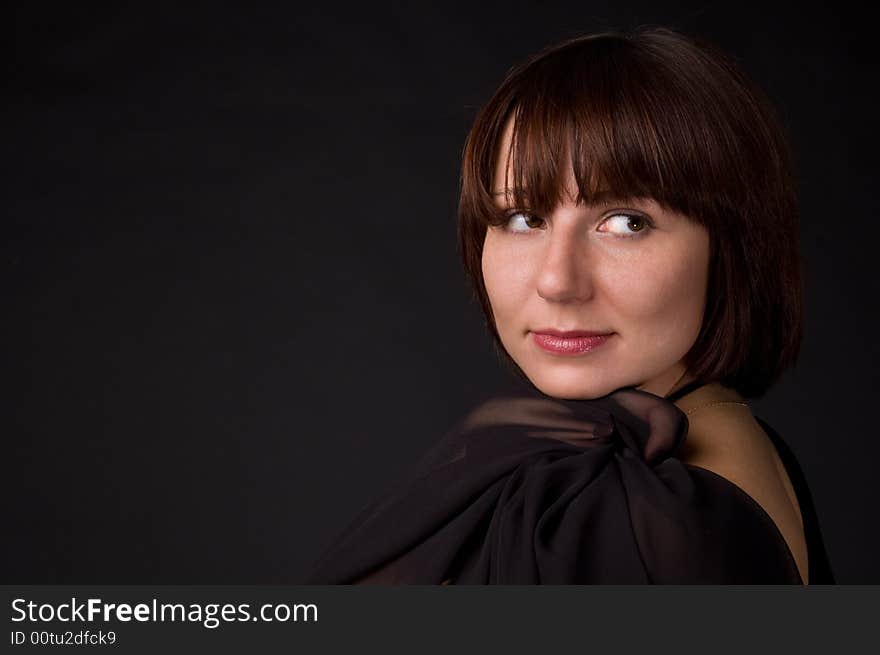 The woman in a dress on a black background