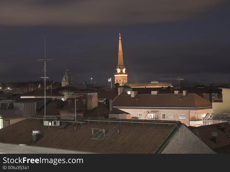 House roofs and a church in the night. House roofs and a church in the night